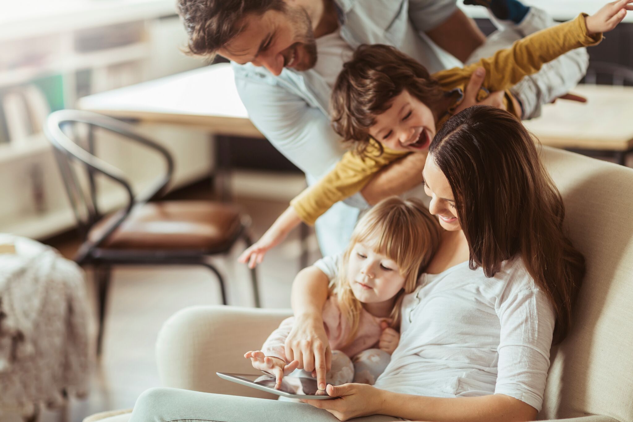 Happy family playing on iPad